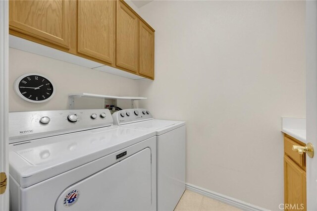 23820 Towish Dr, Corona, CA 92883 - laundry room featuring washing machine and dryer, cabinet space, baseboards, and light tile patterned floors