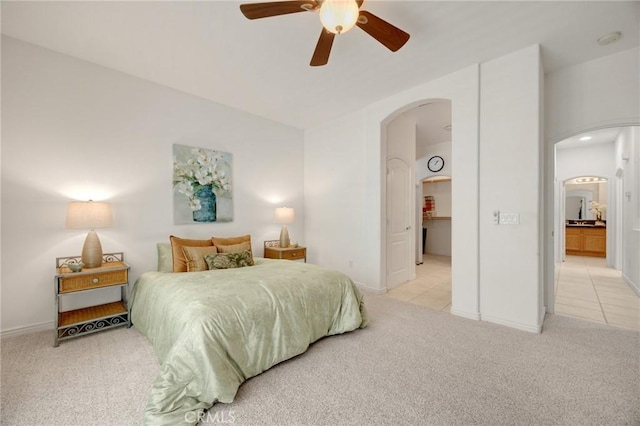 23820 Towish Dr, Corona, CA 92883 - bedroom with arched walkways, light carpet, baseboards, and a ceiling fan