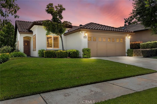 23820 Towish Dr, Corona, CA 92883 - mediterranean / spanish home featuring driveway, an attached garage, a tile roof, a yard, and stucco siding
