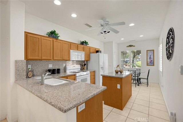 23820 Towish Dr, Corona, CA 92883 - kitchen featuring white appliances, a sink, a center island, decorative backsplash, and light stone countertops