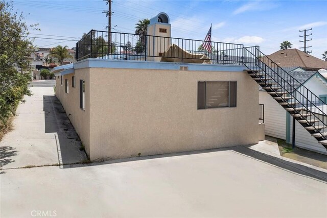 737 Carnelian St, Redondo Beach, CA 90277 - rear view of house with stucco siding, a patio, and stairway