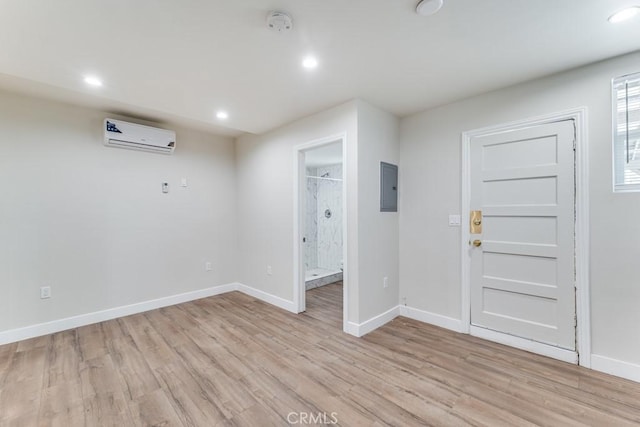 2756 W 15th St, Los Angeles, CA 90006 - foyer with electric panel, light wood-style flooring, a wall mounted air conditioner, baseboards, and recessed lighting