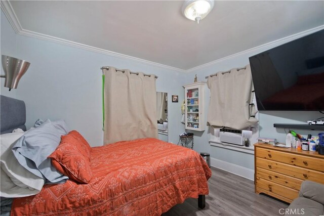2756 W 15th St, Los Angeles, CA 90006 - bedroom featuring wood finished floors, ornamental molding, cooling unit, and baseboards