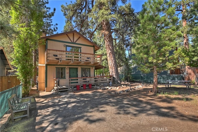 320 W Aeroplane Blvd, Big Bear City, CA 92314 - back of property featuring a chimney, a wooden deck, and a balcony
