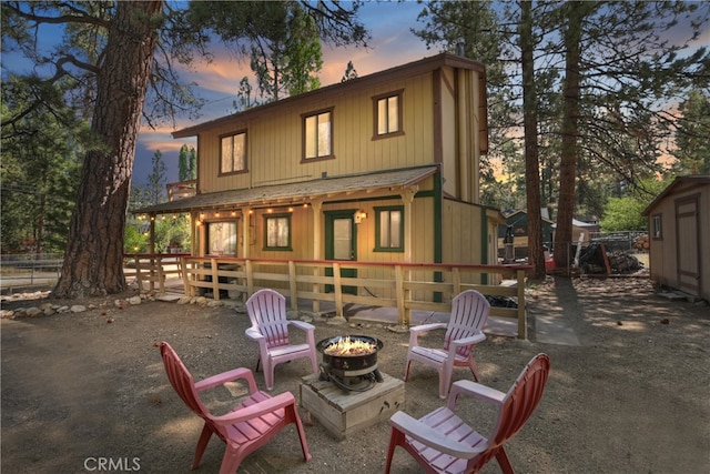 320 W Aeroplane Blvd, Big Bear City, CA 92314 - back of property at dusk with an outdoor fire pit
