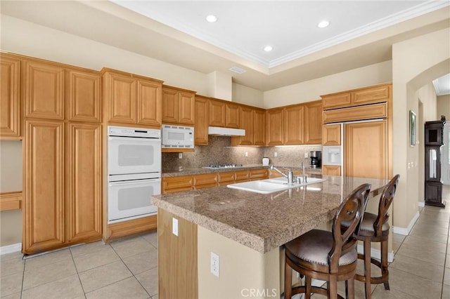 20130 Thagard Way, Yorba Linda, CA 92887 - kitchen featuring a sink, built in appliances, light tile patterned floors, backsplash, and crown molding