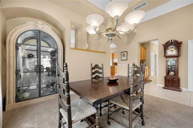 20130 Thagard Way, Yorba Linda, CA 92887 - dining space featuring a chandelier, arched walkways, light tile patterned flooring, light carpet, and baseboards