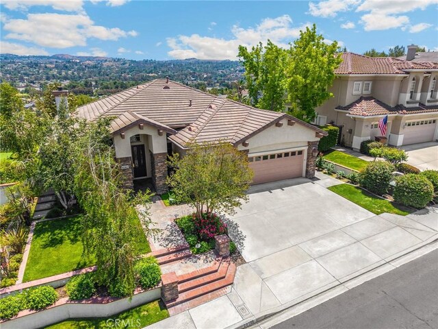 20130 Thagard Way, Yorba Linda, CA 92887 - view of front of house featuring stone siding, a tiled roof, stucco siding, and concrete driveway