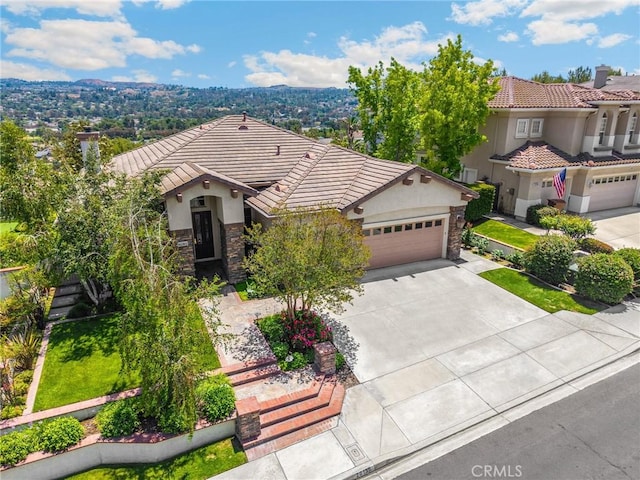 20130 Thagard Way, Yorba Linda, CA 92887 - view of front facade with stone siding, a tiled roof, stucco siding, and concrete driveway
