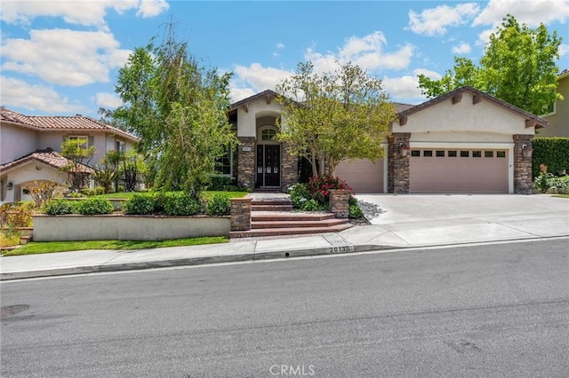 20130 Thagard Way, Yorba Linda, CA 92887 - view of front of property featuring stucco siding, a garage, driveway, and stone siding