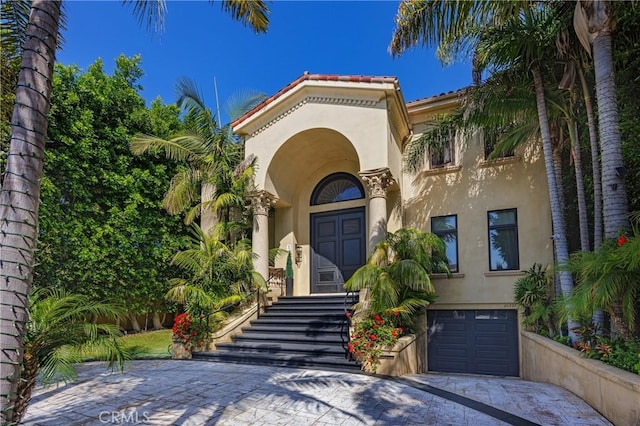 20391 Cypress St, Newport Beach, CA 92660 - entrance to property with stucco siding, driveway, and an attached garage
