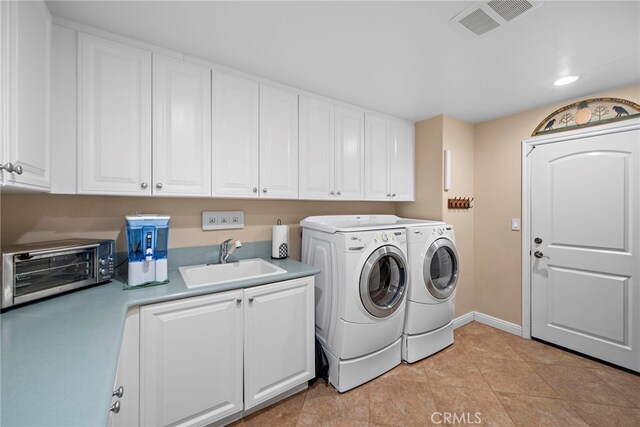 7 Illuminata Ln, Ladera Ranch, CA 92694 - washroom featuring washer and clothes dryer, baseboards, light tile patterned floors, and cabinet space