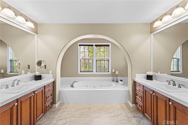7 Illuminata Ln, Ladera Ranch, CA 92694 - full bath with two vanities, a jetted tub, and healthy amount of natural light
