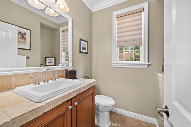 7 Illuminata Ln, Ladera Ranch, CA 92694 - bathroom featuring toilet, vanity, baseboards, tile patterned floors, and crown molding