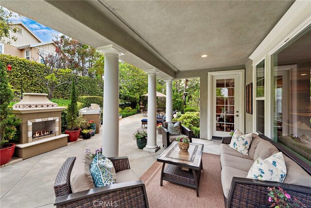 7 Illuminata Ln, Ladera Ranch, CA 92694 - view of patio / terrace with an outdoor living space with a fireplace