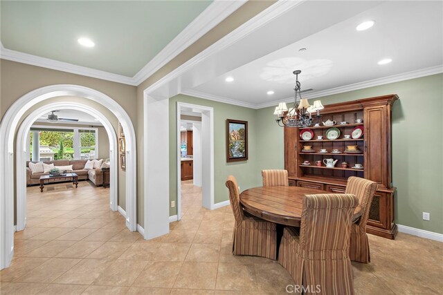 7 Illuminata Ln, Ladera Ranch, CA 92694 - dining space featuring crown molding, a chandelier, recessed lighting, baseboards, and arched walkways