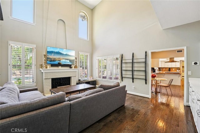 1623 Northhampton Dr, Riverside, CA 92506 - living area with a high ceiling, dark wood finished floors, and a brick fireplace