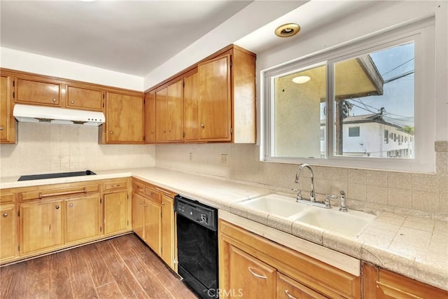 2018 Las Vegas, Pomona, CA 91767 - kitchen with black appliances, under cabinet range hood, light countertops, backsplash, and wood finished floors