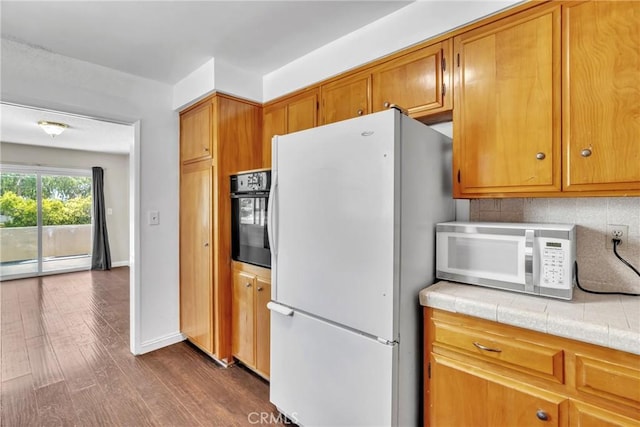 2018 Las Vegas, Pomona, CA 91767 - kitchen with white appliances, baseboard heating, dark wood finished floors, tile counters, and brown cabinets