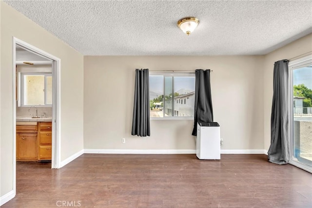 2018 Las Vegas, Pomona, CA 91767 - unfurnished room featuring dark wood-style flooring and a textured ceiling