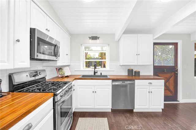 9 W Avenida Cornelio, San Clemente, CA 92672 - kitchen with butcher block counters, appliances with stainless steel finishes, a sink, dark wood-style floors, and tasteful backsplash