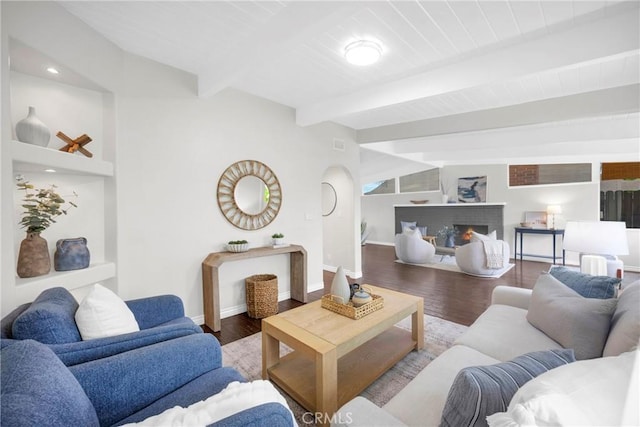 9 W Avenida Cornelio, San Clemente, CA 92672 - living room with beam ceiling, baseboards, wood finished floors, and a warm lit fireplace