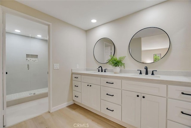 5697 Los Robles, La Verne, CA 91750 - bathroom with double vanity, wood finished floors, a stall shower, recessed lighting, and baseboards