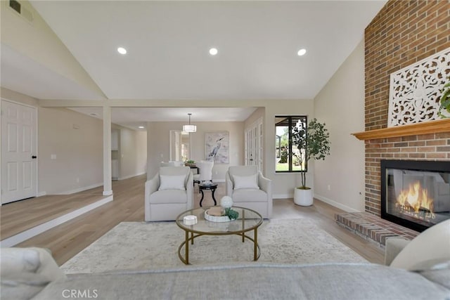 5697 Los Robles, La Verne, CA 91750 - living room with vaulted ceiling, wood finished floors, a fireplace, baseboards, and recessed lighting
