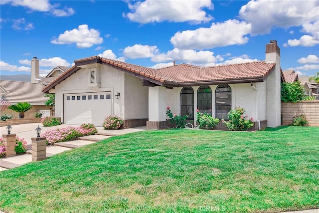 5697 Los Robles, La Verne, CA 91750 - mediterranean / spanish-style house with stucco siding, a front yard, a tiled roof, an attached garage, and driveway