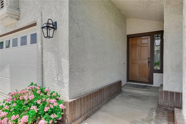 5697 Los Robles, La Verne, CA 91750 - view of exterior entry with stucco siding and a garage
