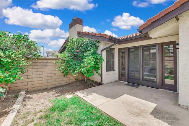 5697 Los Robles, La Verne, CA 91750 - entrance to property with a patio, a chimney, a tile roof, and stucco siding