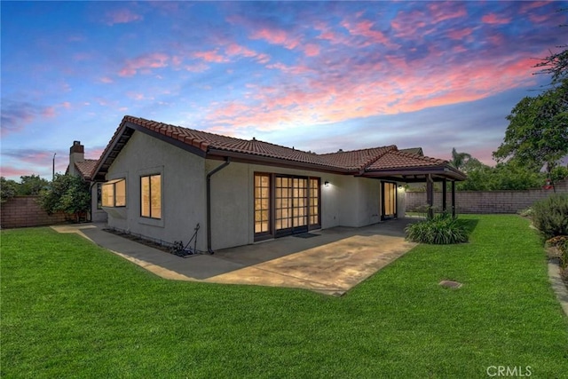 5697 Los Robles, La Verne, CA 91750 - back of house at dusk with a tile roof, a patio area, and stucco siding