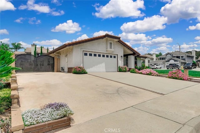 5697 Los Robles, La Verne, CA 91750 - ranch-style house with a gate, driveway, an attached garage, stucco siding, and a residential view