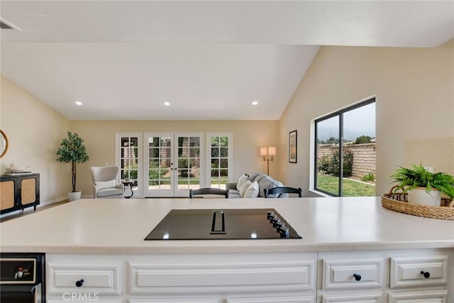 5697 Los Robles, La Verne, CA 91750 - kitchen featuring open floor plan, black electric stovetop, light countertops, white cabinetry, and lofted ceiling