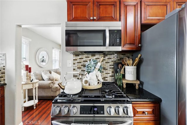 210 W Tichenor St, Compton, CA 90220 - kitchen with stainless steel appliances, decorative backsplash, dark wood-type flooring, and dark stone countertops