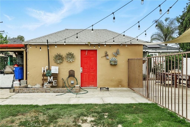 210 W Tichenor St, Compton, CA 90220 - rear view of property with stucco siding and a patio area