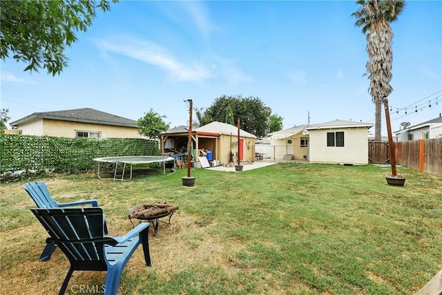 210 W Tichenor St, Compton, CA 90220 - view of yard featuring a trampoline, an outdoor fire pit, and a patio