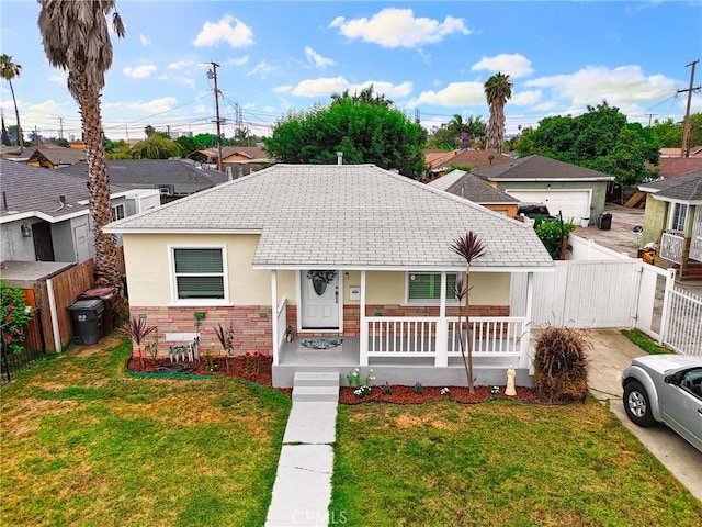 210 W Tichenor St, Compton, CA 90220 - view of front of home featuring covered porch, stucco siding, and brick siding
