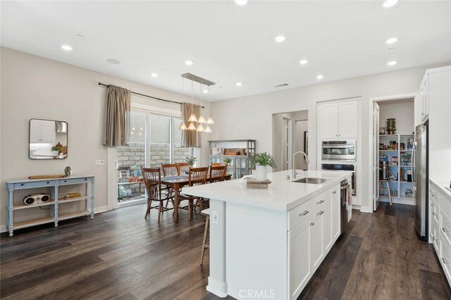 27227 Coyote Bush Ct, Valencia, CA 91381 - kitchen featuring stainless steel appliances, a sink, dark wood-type flooring, light countertops, and recessed lighting