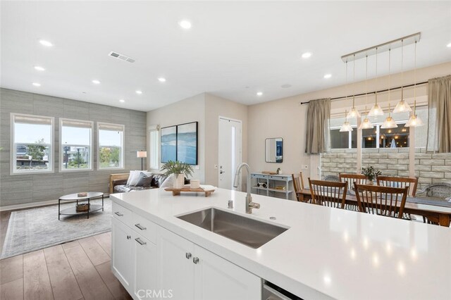 27227 Coyote Bush Ct, Valencia, CA 91381 - kitchen featuring open floor plan, a sink, wood finished floors, light countertops, and recessed lighting