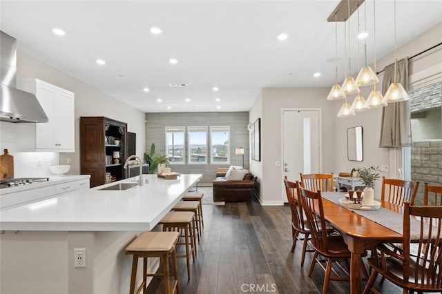 27227 Coyote Bush Ct, Valencia, CA 91381 - kitchen with a sink, wall chimney range hood, dark wood finished floors, recessed lighting, and light countertops
