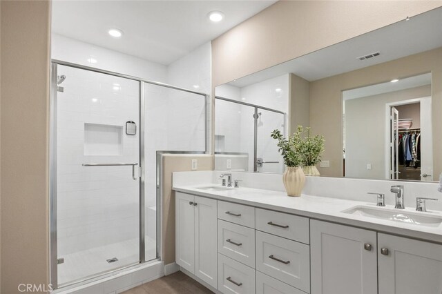 27227 Coyote Bush Ct, Valencia, CA 91381 - bathroom featuring double vanity, a shower stall, a spacious closet, and recessed lighting