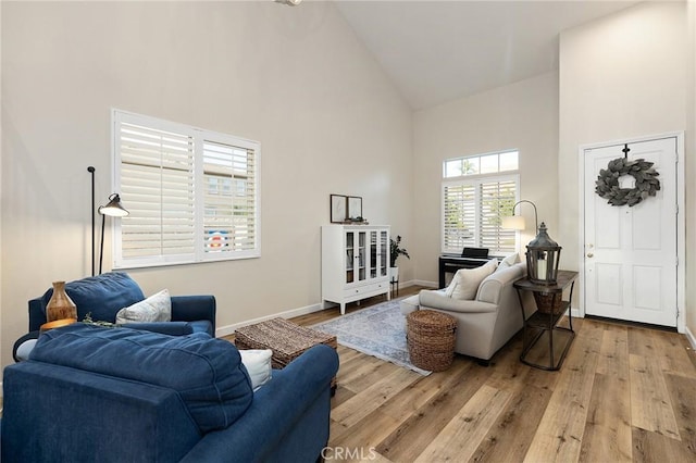 7476 Sequoia Ln, Highland, CA 92346 - living area with high vaulted ceiling, wood finished floors, and baseboards