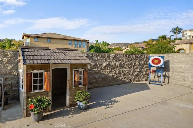 7476 Sequoia Ln, Highland, CA 92346 - gate with a fenced backyard, a patio area, and an outdoor structure