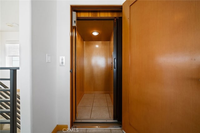 210 El Porto St, Manhattan Beach, CA 90266 - corridor with elevator, tile patterned floors, and baseboards