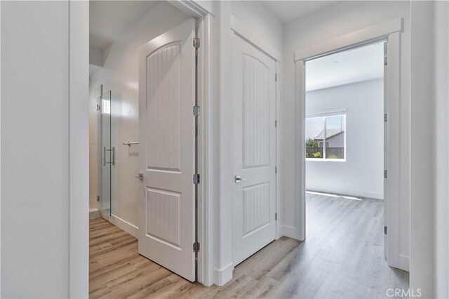 1734 Lester Ave, Clovis, CA 93619 - hallway featuring light wood-type flooring and baseboards