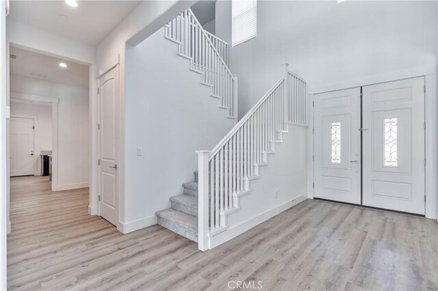1734 Lester Ave, Clovis, CA 93619 - entryway featuring stairway, light wood-style floors, recessed lighting, a towering ceiling, and baseboards