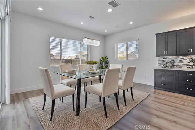 1734 Lester Ave, Clovis, CA 93619 - dining area with light wood-style flooring, recessed lighting, baseboards, and a chandelier