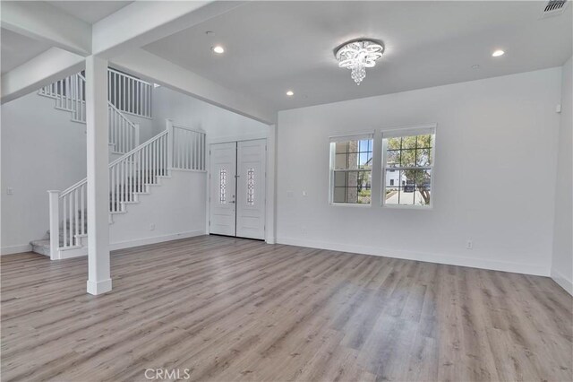 1734 Lester Ave, Clovis, CA 93619 - unfurnished living room with stairway, wood finished floors, baseboards, and recessed lighting