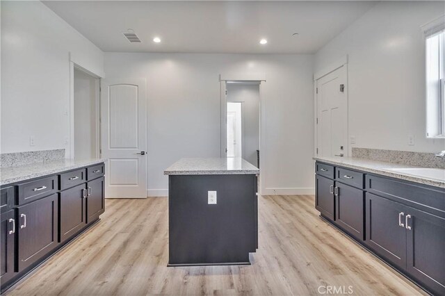 1734 Lester Ave, Clovis, CA 93619 - kitchen with a sink, light wood finished floors, a center island, recessed lighting, and baseboards